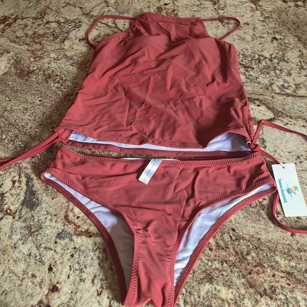 Tankini swimsuit. Top has padding but no underwire. Color is rust